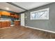 Kitchen featuring hardwood floors connecting to a modern gray room and a white door at 4249 Dubarry Rd, Indianapolis, IN 46226