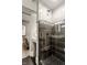 Sleek bathroom featuring modern shower with black tile and unique patterned floor at 501 Fletcher Ave # D, Indianapolis, IN 46203