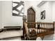Staircase featuring wood railing leads to the unique wooden front door at 501 Fletcher Ave # D, Indianapolis, IN 46203