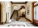 Grand entryway with tile floors, archways, and staircase at 501 Fletcher Ave # D, Indianapolis, IN 46203