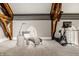 Bright exercise room with exposed wooden beams, lounge and modern equipment by a stained glass window at 501 Fletcher Ave # D, Indianapolis, IN 46203