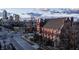 An aerial view of a brick church with a view of downtown buildings under a cloudy sky on a sunny day at 501 Fletcher Ave # D, Indianapolis, IN 46203