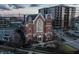 An aerial view of a beautiful brick church next to a modern building at dusk, showing the buildings' architecture at 501 Fletcher Ave # D, Indianapolis, IN 46203