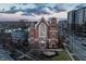 An aerial view of a beautiful brick church with manicured landscaping with another modern building nearby at 501 Fletcher Ave # D, Indianapolis, IN 46203