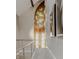 Hallway featuring stained-glass window, artwork, and stainless steel cable railing at 501 Fletcher Ave # D, Indianapolis, IN 46203