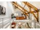 Spacious living room featuring exposed wooden beams, tall ceilings, and an open floor plan at 501 Fletcher Ave # D, Indianapolis, IN 46203