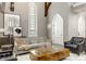 Comfortable living room featuring stained glass windows, neutral decor, and a large tufted sofa at 501 Fletcher Ave # D, Indianapolis, IN 46203