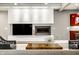Modern living room features a sleek fireplace, textured wall, and minimalist design elements at 501 Fletcher Ave # D, Indianapolis, IN 46203