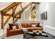 Inviting living room featuring a leather sofa, stylish accents, and unique architectural details at 501 Fletcher Ave # D, Indianapolis, IN 46203