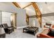 Cozy living space with vaulted ceilings, exposed beams, and access to modern bathroom at 501 Fletcher Ave # D, Indianapolis, IN 46203