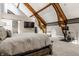 Bright main bedroom showcasing exposed beams, vaulted ceilings, and contemporary decor at 501 Fletcher Ave # D, Indianapolis, IN 46203