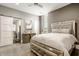 Main bedroom featuring stylish bed, artwork, stained glass window, barn door to ensuite bath at 501 Fletcher Ave # D, Indianapolis, IN 46203