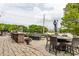Charming outdoor patio with tables, chairs, and lush landscaping at 501 Fletcher Ave # D, Indianapolis, IN 46203
