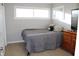 Bright bedroom featuring a cozy bed, wood-look floors, and ample natural light at 516 Northfield Dr, Lebanon, IN 46052