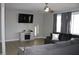 Cozy living room featuring a plush gray sofa, modern entertainment center, and ample natural light at 516 Northfield Dr, Lebanon, IN 46052
