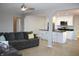 Open-concept living space featuring a modern kitchen and a cozy living room with a gray sofa at 516 Northfield Dr, Lebanon, IN 46052