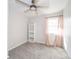 Neutral bedroom with a ceiling fan, large window, and a built-in bookshelf at 540 Barnett Ct, Whiteland, IN 46184