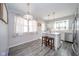 Bright dining area featuring a modern chandelier, kitchen island, and view to updated kitchen at 540 Barnett Ct, Whiteland, IN 46184