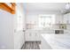 Beautiful white kitchen with white marble countertops, backsplash and gold hardware at 540 Barnett Ct, Whiteland, IN 46184