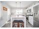 Updated kitchen boasts a stylish island with barstool seating and stainless steel appliances at 540 Barnett Ct, Whiteland, IN 46184