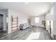 Inviting living room showcasing stylish gray flooring, natural light, and modern decor at 540 Barnett Ct, Whiteland, IN 46184