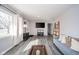 Spacious living room featuring gray flooring, open layout, and large windows for natural light at 540 Barnett Ct, Whiteland, IN 46184