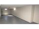 Basement features painted walls and floors, a storage rack, and small windows along the wall at 5502 Radnor Rd, Indianapolis, IN 46226