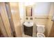 Bathroom featuring a cream tile wall, dark vanity, standard toilet, and a framed mirror at 5502 Radnor Rd, Indianapolis, IN 46226