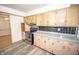 Kitchen featuring wood cabinets, stainless steel appliances, and vinyl floors at 5502 Radnor Rd, Indianapolis, IN 46226