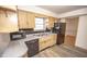 Well-lit kitchen featuring wooden cabinetry, appliances, sink, and tile backsplash at 5502 Radnor Rd, Indianapolis, IN 46226