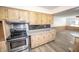 Bright kitchen showcases light wooden cabinets, stainless steel oven, and black tiled backsplash at 5502 Radnor Rd, Indianapolis, IN 46226