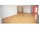 A spacious living room offers light wood floors, neutral walls, and a bright coral front door at 5502 Radnor Rd, Indianapolis, IN 46226