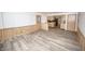 A living room features hardwood floors, wood paneling, and an open entry to the kitchen at 5502 Radnor Rd, Indianapolis, IN 46226