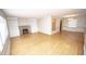 A bright living room features hardwood floors, a fireplace with built-in shelves, and large windows at 5502 Radnor Rd, Indianapolis, IN 46226