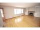 Living room features light hardwood floors, a fireplace with built-in shelving and a large window at 5502 Radnor Rd, Indianapolis, IN 46226