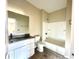 The bathroom features modern fixtures, granite countertop, and a shower-tub combo, offering a sleek and functional design at 614 Silver Fox Ct, Indianapolis, IN 46217