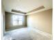 Bright bedroom features neutral walls, a tray ceiling, recessed lighting, and a large window at 614 Silver Fox Ct, Indianapolis, IN 46217