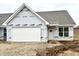 New home exterior features a white garage door, white front door, gray shingle roof and large window at 614 Silver Fox Ct, Indianapolis, IN 46217