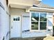 New construction home entrance featuring a white door, rectangular window, and materials to weatherproof the exterior at 614 Silver Fox Ct, Indianapolis, IN 46217
