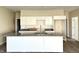Kitchen featuring a large island with granite countertop, white cabinets, and stainless steel faucet at 614 Silver Fox Ct, Indianapolis, IN 46217