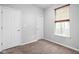 Neutral-toned bedroom with closet and window providing natural light at 6537 Amherst Way, Zionsville, IN 46077