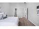 Clean bedroom featuring neutral decor, a cozy bed, and open doorways to the bathroom and closet at 6537 Amherst Way, Zionsville, IN 46077