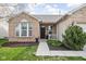 Inviting home exterior with brick accents, a cozy porch, and a well-kept lawn and landscape at 6537 Amherst Way, Zionsville, IN 46077