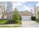 Charming single-story brick home with a well-manicured lawn and an attached two-car garage at 6537 Amherst Way, Zionsville, IN 46077