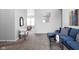 Stylish living room featuring a blue velvet sectional, modern decor, and neutral-toned carpeting at 6537 Amherst Way, Zionsville, IN 46077