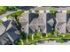 An aerial view of townhomes displays landscaped yards, elegant roofs, and manicured lawns with a neighboring street at 6691 Beekman Pl, Zionsville, IN 46077