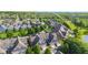 Overhead view of neighborhood houses with garages nestled between trees, showing a well-planned layout at 6691 Beekman Pl, Zionsville, IN 46077