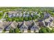 Aerial shot of townhomes with peaked roofs, showcasing well-maintained garages and lovely green landscaping at 6691 Beekman Pl, Zionsville, IN 46077