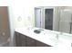 Bright bathroom featuring a double sink vanity, large mirror, and walk-in closet, creating a refreshing and functional space at 6691 Beekman Pl, Zionsville, IN 46077
