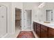 Bright bathroom with a glass-enclosed shower and dual sinks at 6691 Beekman Pl, Zionsville, IN 46077